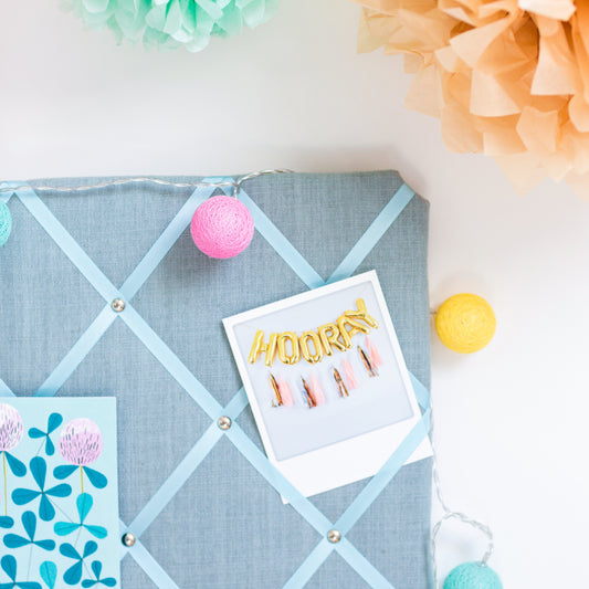 Close-up of grosgrain ribbon and stud detail on Duck Egg Blue notice board