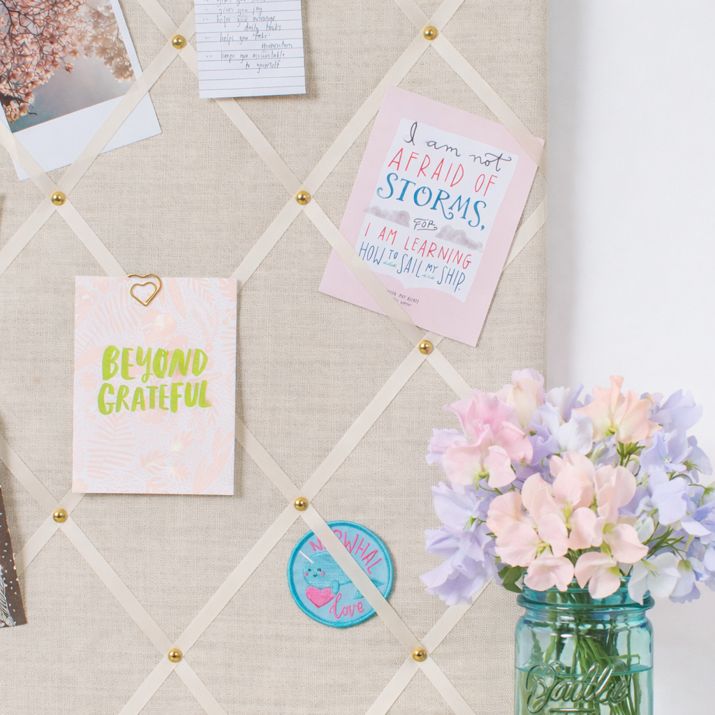 Ivory fabric notice board holding notes and photos without pins