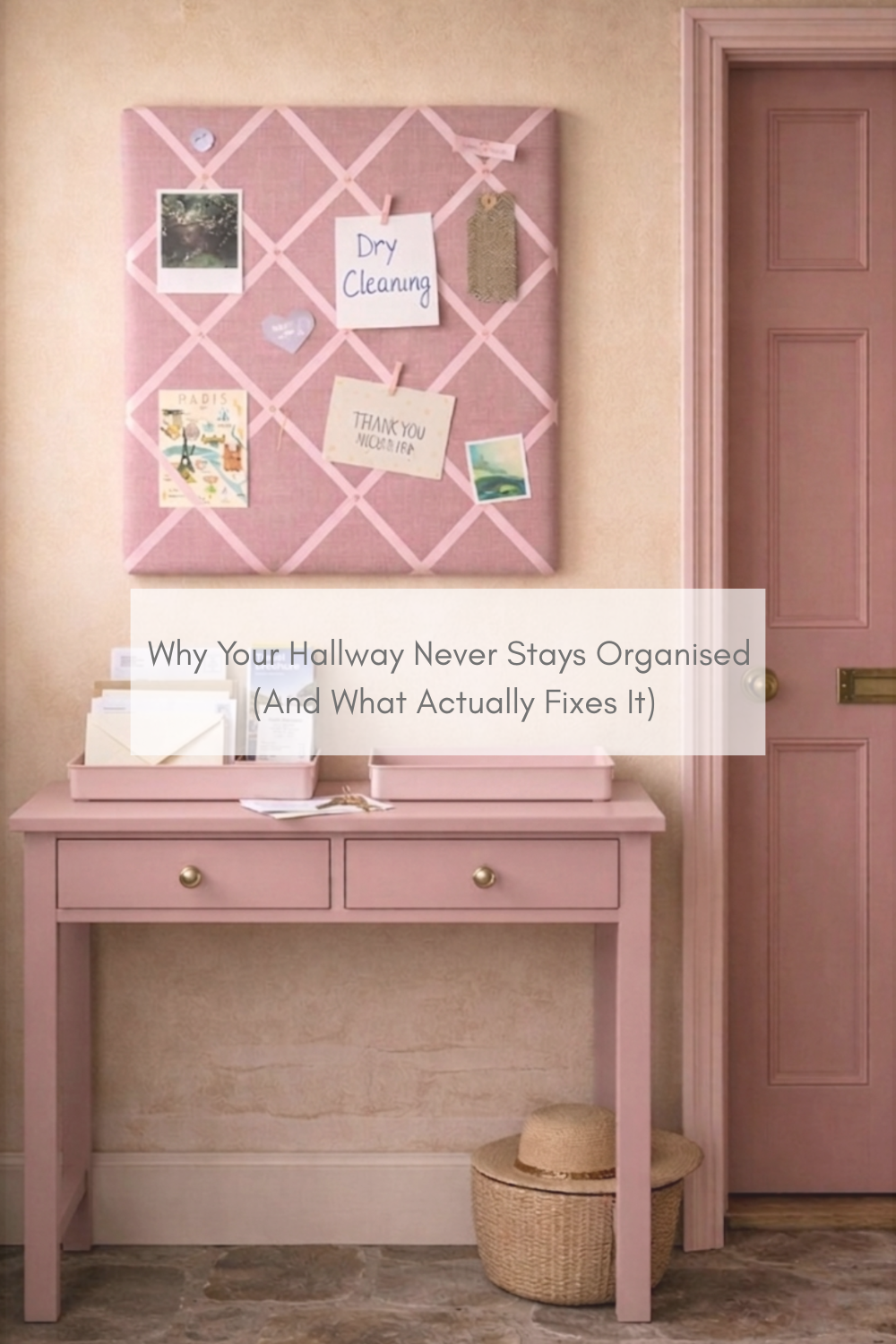 Pink hallway with a fabric notice board above a table holding letters and notes, showing a simple system to organise everyday clutter in a real home