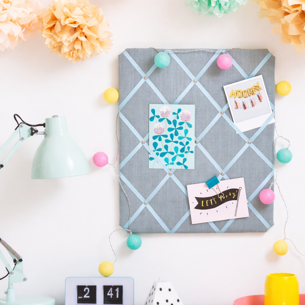 Duck Egg Blue fabric notice board holding notes and photos under ribbons no damage