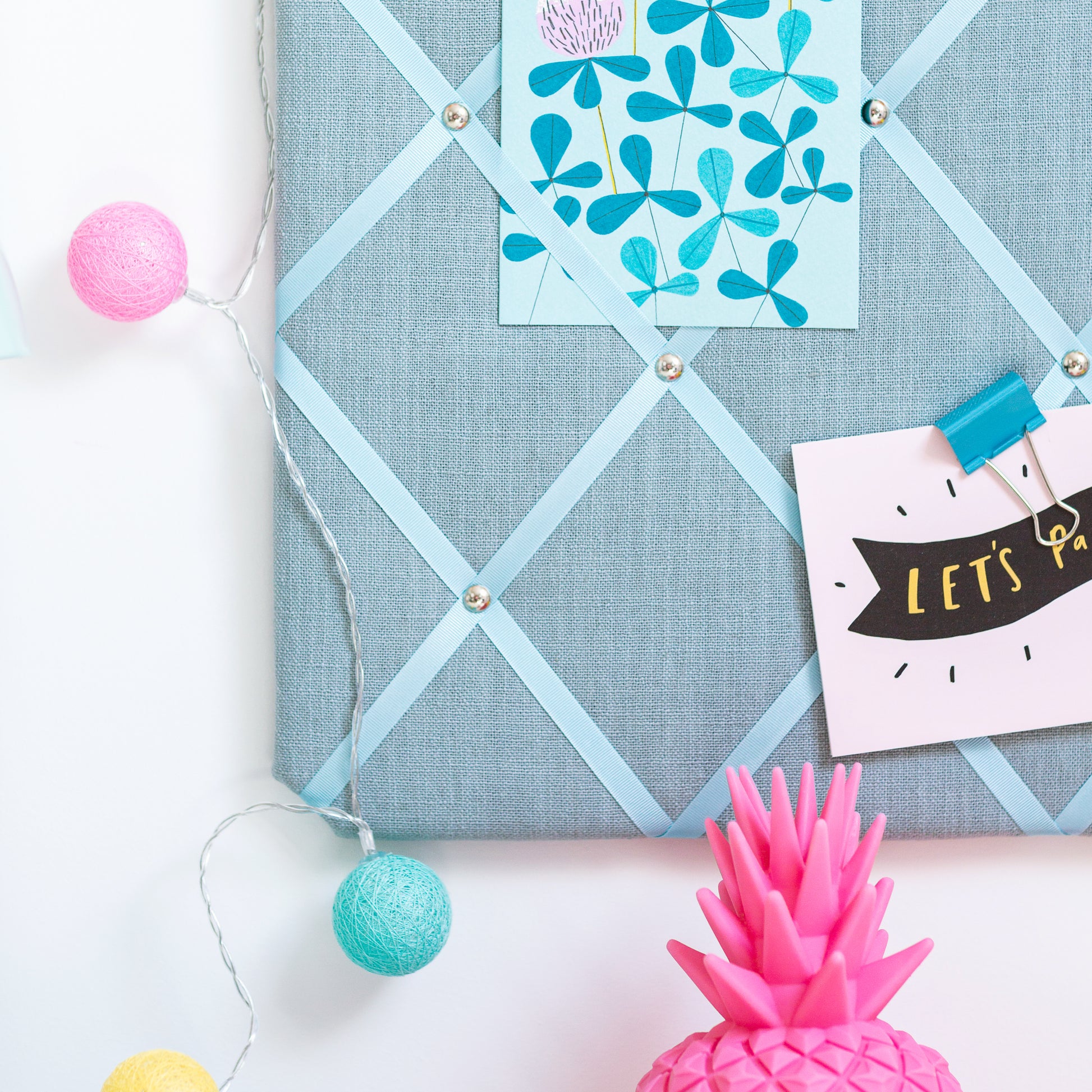 Duck Egg Blue fabric notice board holding notes and photos without pins
