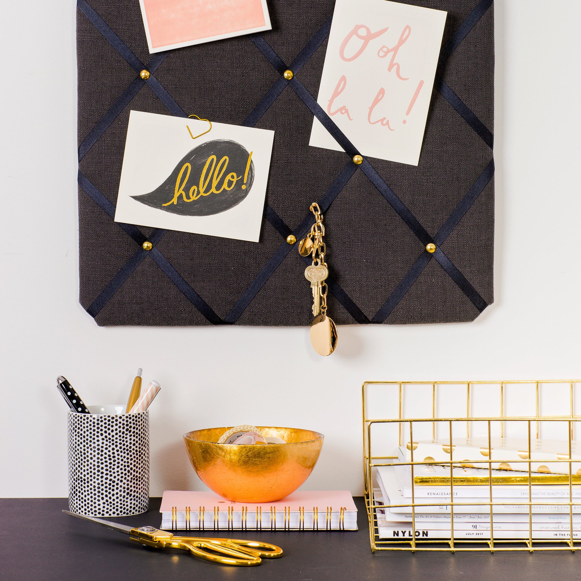 Charcoal fabric notice board holding notes and cards without pins
