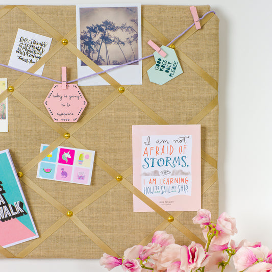Close-up of grosgrain ribbon and stud detail on Tobacco Gold notice board
